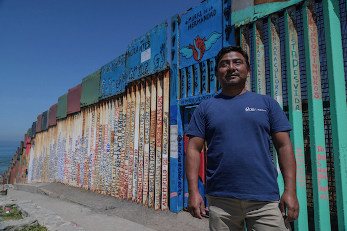hombre frente a la frontera Mexico-Estados Unidos.